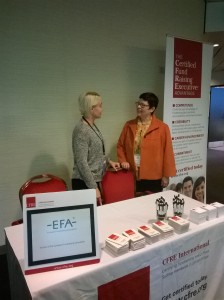 Pia Tornikosdki, Secretary General of VaLa - the Finnish Fundraising Association chats with Eva E. Aldrich, M.A., CFRE at the CFRE International booth at IFC 2015