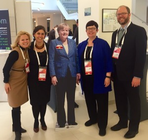 Posing with with a cutout of German Chancellor Angela Merkel. 