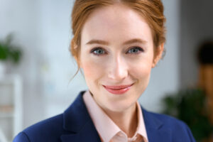 Woman in suit smiling at camera.